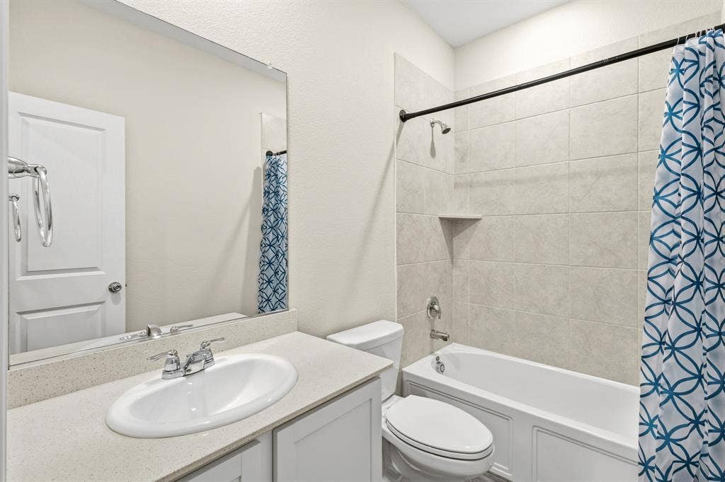 714 Stallings Drive, Princeton, TX 75407 Bathroom featuring a single vanity with a light-toned countertop, an undermount sink, and chrome fixtures