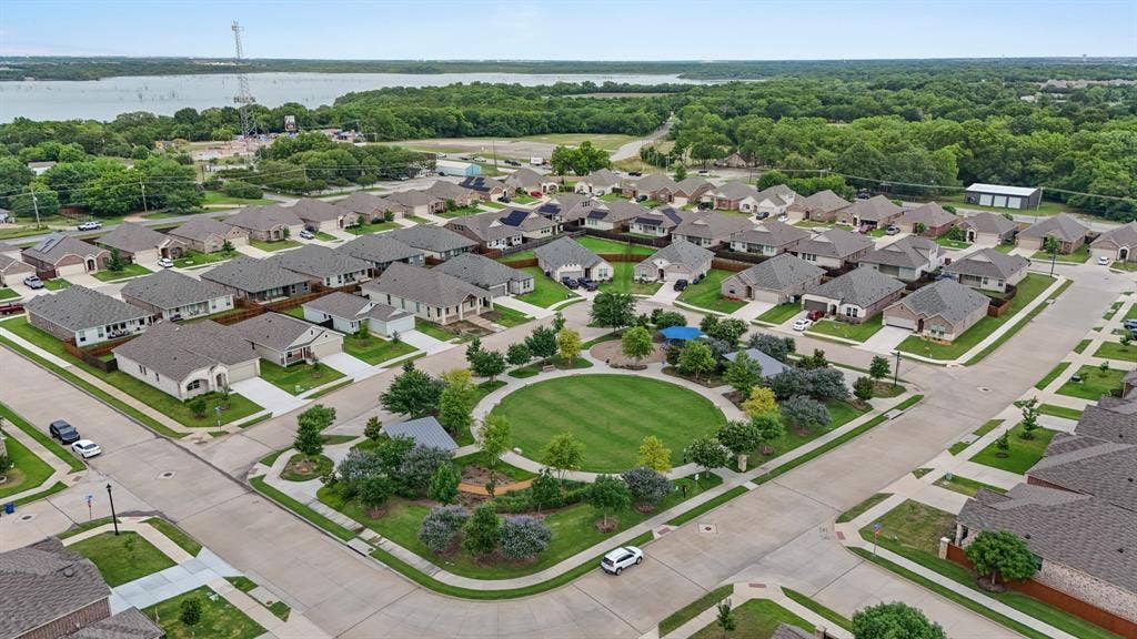714 Stallings Drive, Princeton, TX 75407 Aerial view of a residential community featuring a central green space with walking paths and mature landscaping
