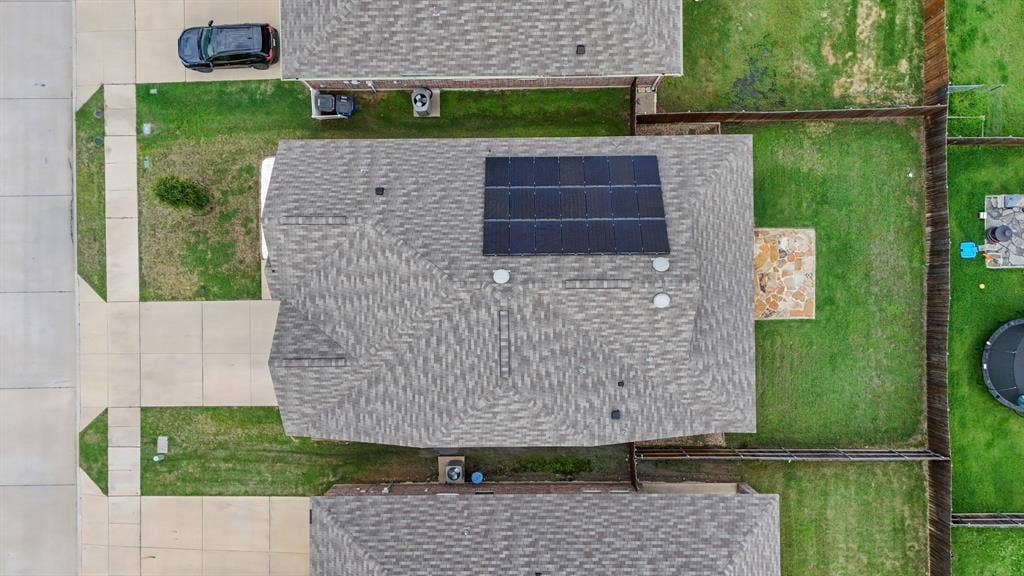 714 Stallings Drive, Princeton, TX 75407 Gray shingle roofing with installed solar panels