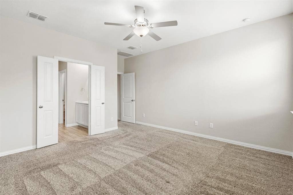 714 Stallings Drive, Princeton, TX 75407 Spacious room with neutral carpet, light gray wall paint, and white trim