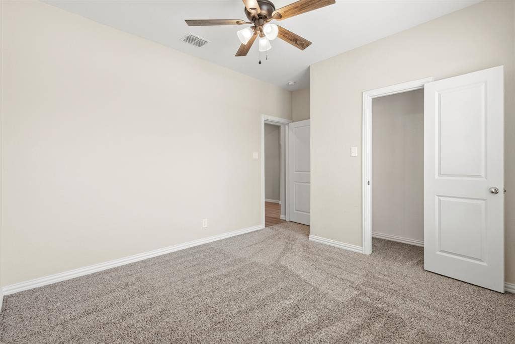 714 Stallings Drive, Princeton, TX 75407 Neutral-toned walls complement the gray carpeting