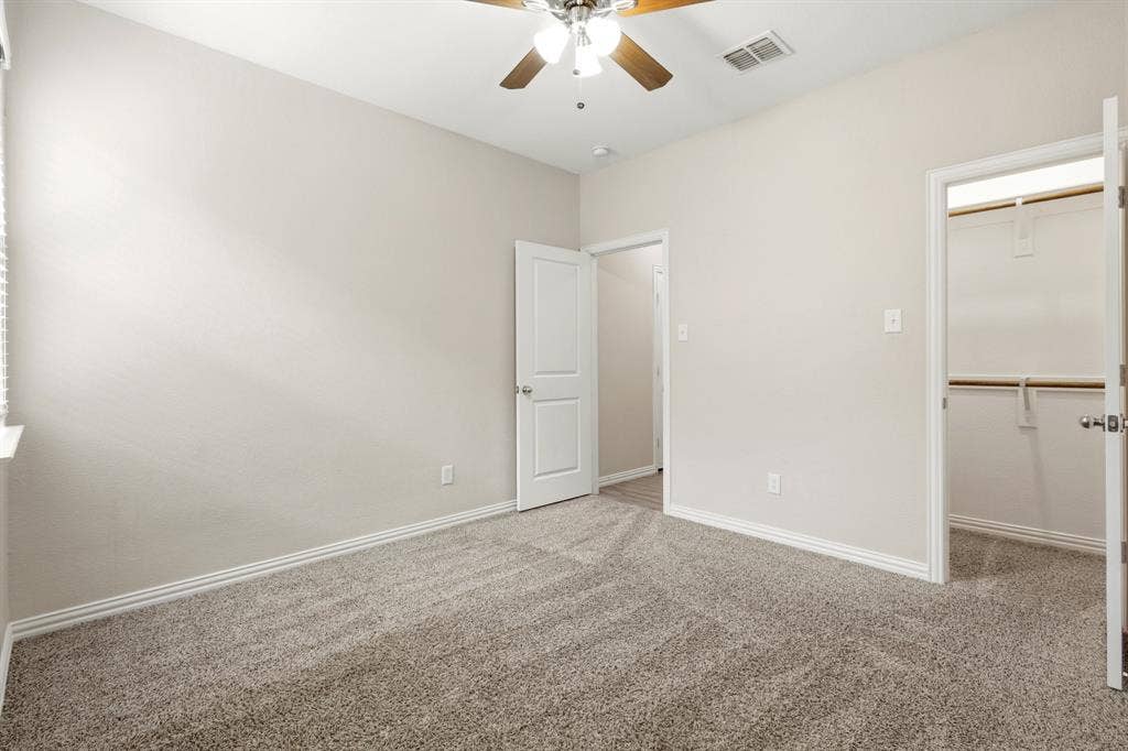 714 Stallings Drive, Princeton, TX 75407 Carpeted room featuring a ceiling fan with light fixture, neutral wall paint, and white baseboards