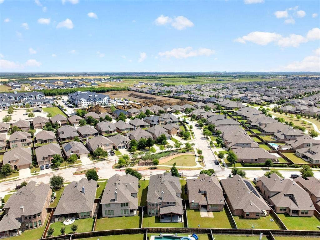 Extensive residential development featuring numerous single-family homes with pitched roofs and manicured lawns