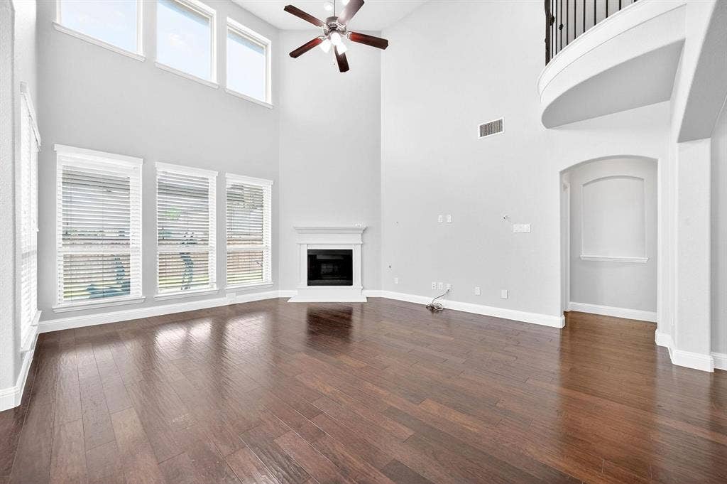 Expansive living area featuring soaring ceilings and dark wood-finish flooring