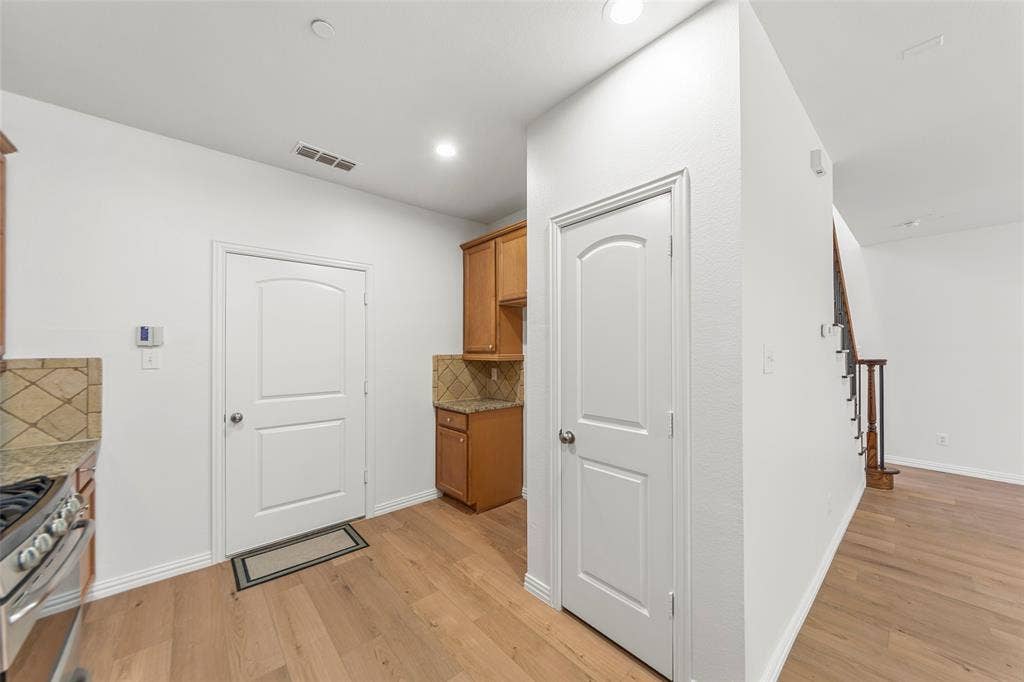 7916 Hannah Street, Plano, TX 75025 Kitchen area featuring light wood-finish flooring, white paneled doors, and recessed lighting