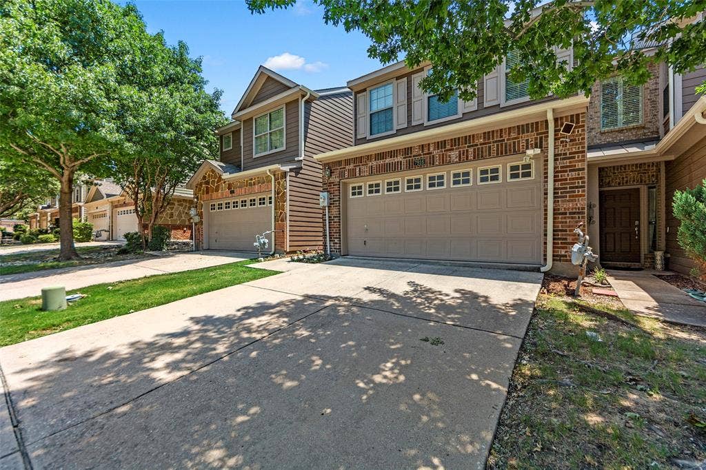 7916 Hannah Street, Plano, TX 75025 Exterior featuring brick and siding facade, an attached two-car garage, and a concrete driveway