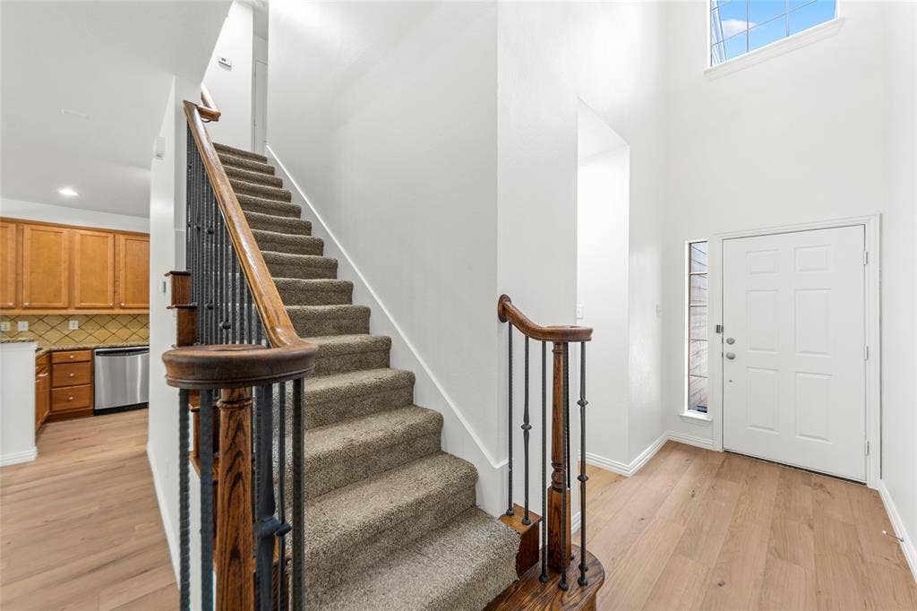 7916 Hannah Street, Plano, TX 75025 Entryway with light wood-finish flooring, a white paneled door, and a tall sidelight window