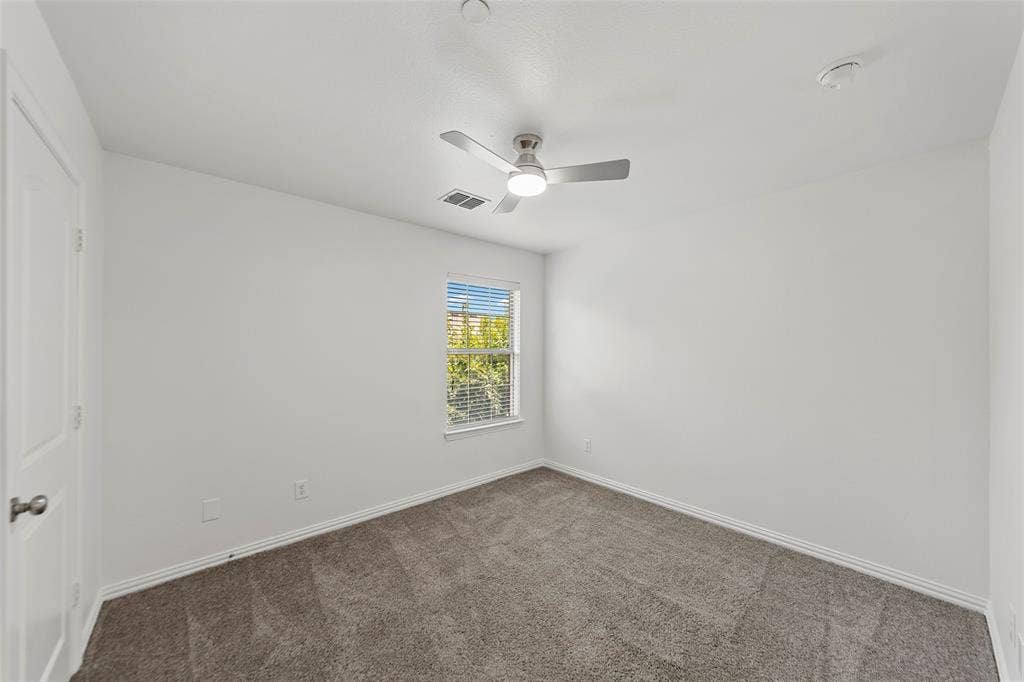 7916 Hannah Street, Plano, TX 75025 Carpeted room featuring a white door, a window with horizontal blinds, a ceiling fan with integrated lighting, and white baseboards