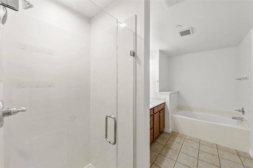 7916 Hannah Street, Plano, TX 75025 Glass-enclosed shower with chrome fixtures
