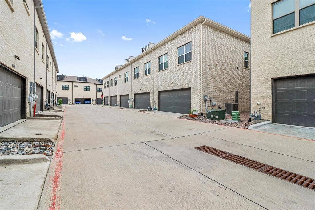 616 Collier Drive, Plano, TX 75075 Concrete driveway providing access to multiple brick-clad townhome units