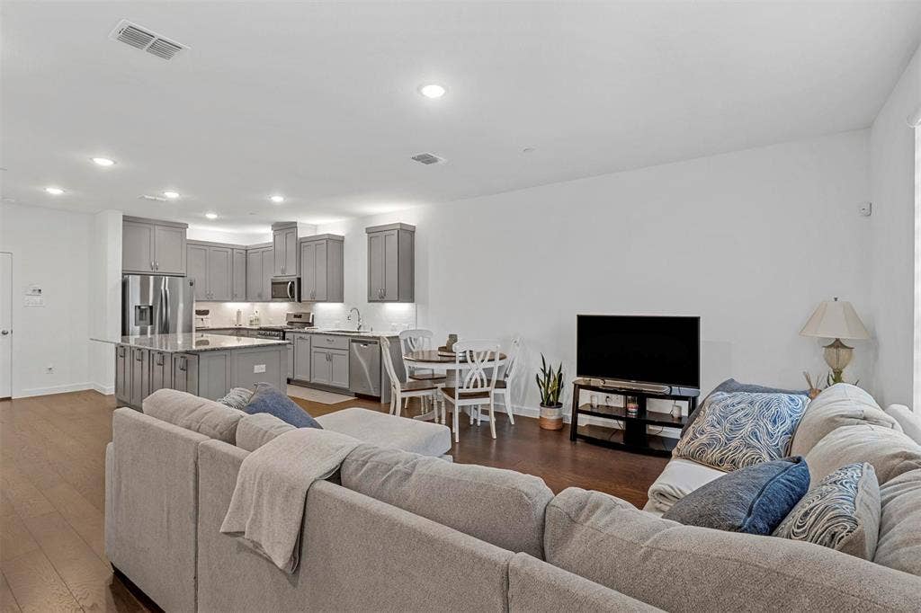 616 Collier Drive, Plano, TX 75075 Open-concept living space featuring wood flooring and recessed lighting