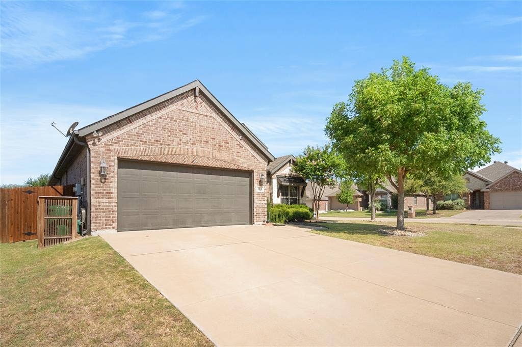 231 Carson Drive, Waxahachie, TX 75167 Wooden trash bin holder on side of home with folding ramp.