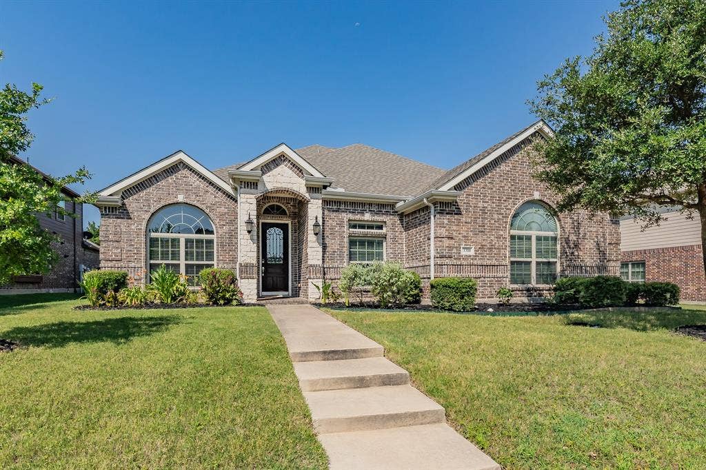 Brick exterior with stone accents and arched window details