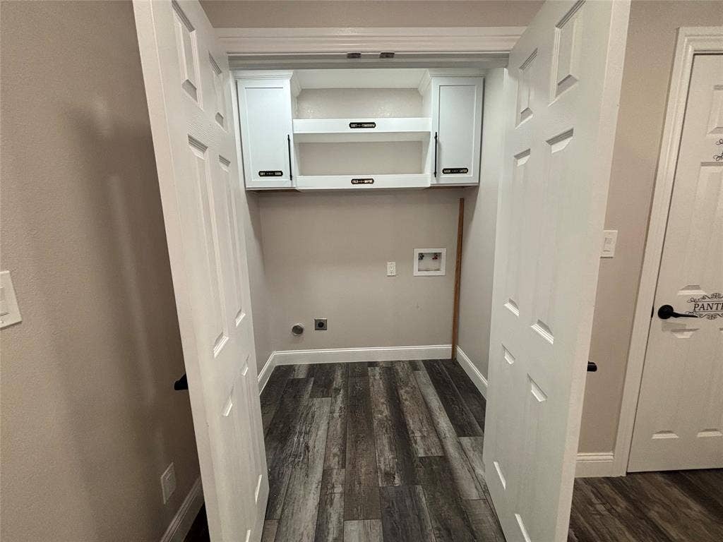 910 NE 31st, Grand Prairie, TX 75050 Dedicated laundry area with durable wood-finish flooring, light gray wall paint, and crisp white baseboards