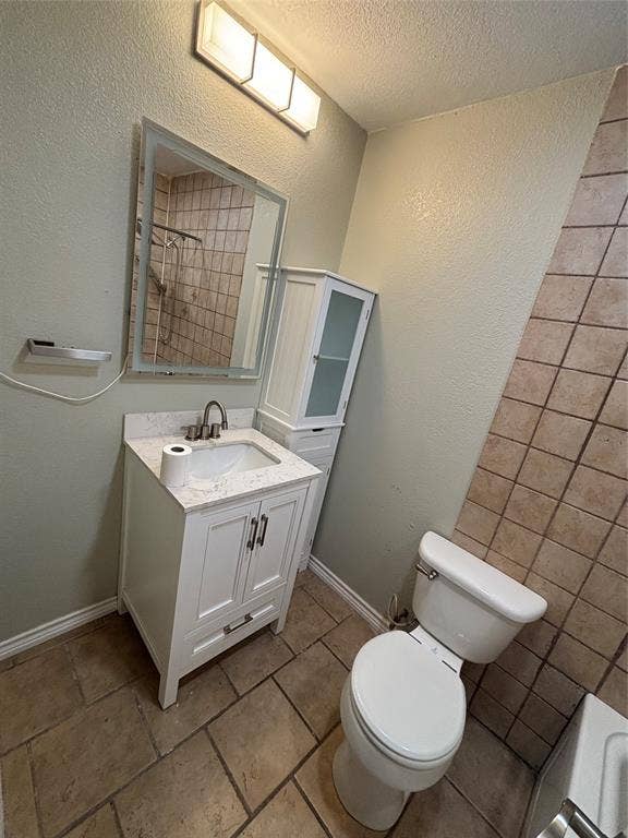 910 NE 31st, Grand Prairie, TX 75050 Contemporary bathroom featuring a white vanity with a rectangular sink, a stone-finish countertop, and brushed nickel hardware