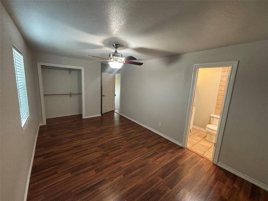 910 NE 31st, Grand Prairie, TX 75050 Bedroom featuring wood-finish flooring, a ceiling fan with integrated lighting, and a window with blinds