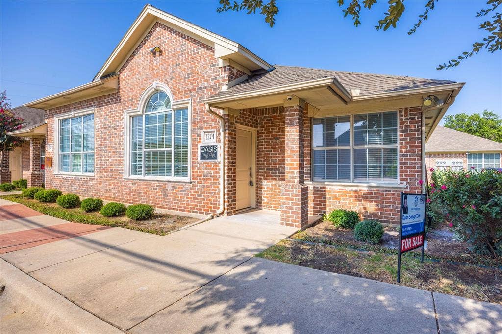 2840 Keller Springs Road, #1201, Carrollton, TX 75006 Brick exterior with arched window, multiple large windows, and established landscaping