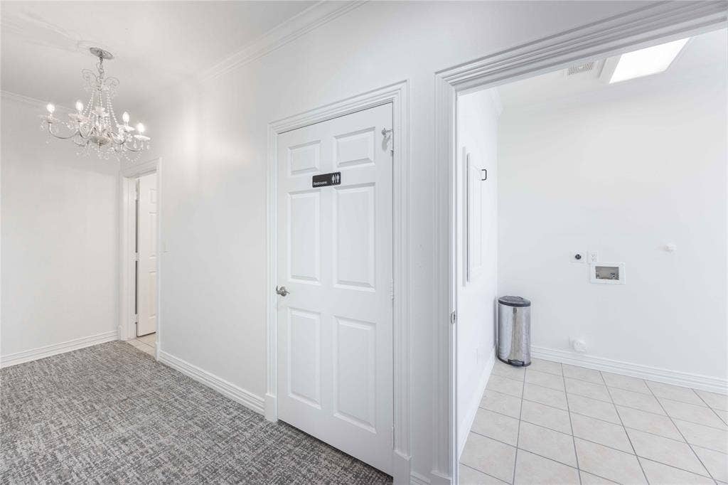 2840 Keller Springs Road, #1201, Carrollton, TX 75006 Chandelier lighting, crown molding, paneled interior door, tiled flooring, and a skylight