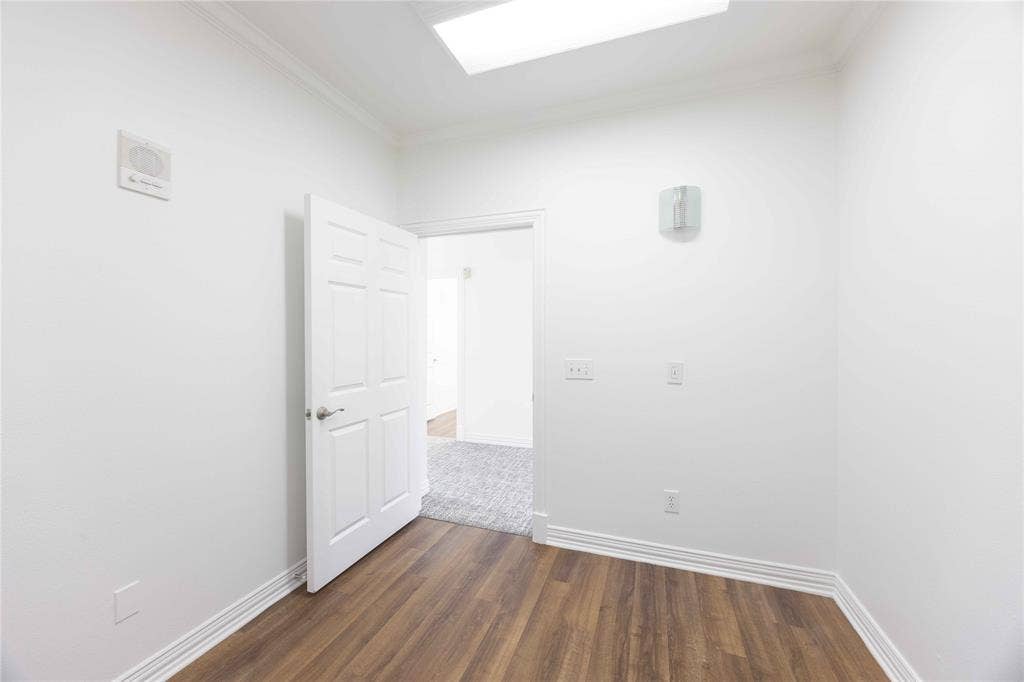 2840 Keller Springs Road, #1201, Carrollton, TX 75006 Wood-finish flooring, white paneled door, crown molding, and recessed lighting