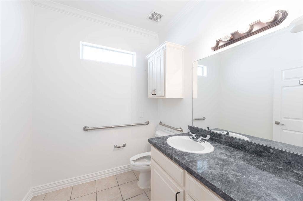 2840 Keller Springs Road, #1201, Carrollton, TX 75006 Vanity with an integrated sink, dark countertop, and large mirror