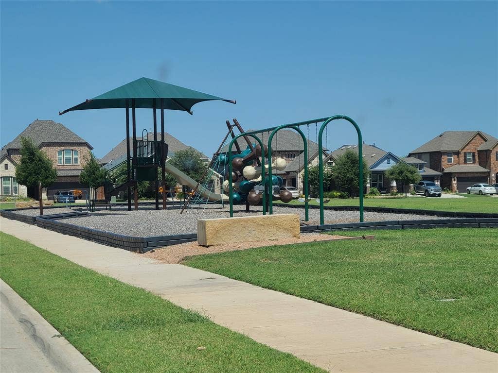 2810 Green Circle Drive, Mansfield, TX 76063 Community playground featuring a multi-level play structure with a shade canopy, slide, and climbing elements