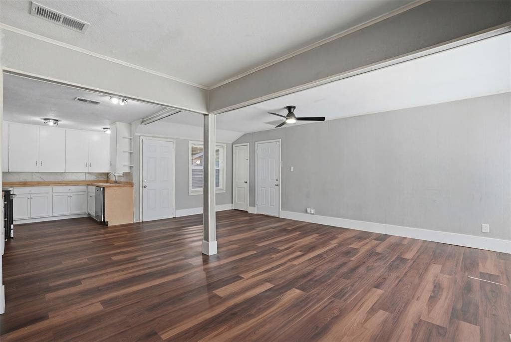 337 N 1st Street, Point, TX 75472 Spacious open-concept living area featuring wood-finish flooring, a ceiling fan, and white trim
