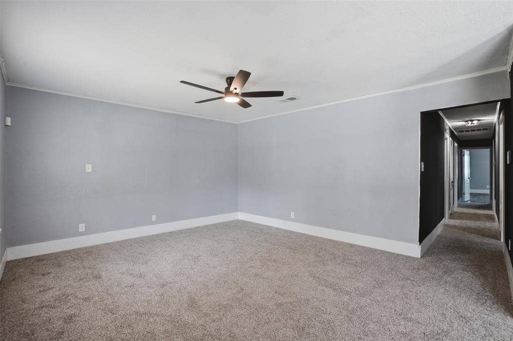 337 N 1st Street, Point, TX 75472 Spacious room featuring light gray walls, white baseboards, and a modern ceiling fan with integrated lighting