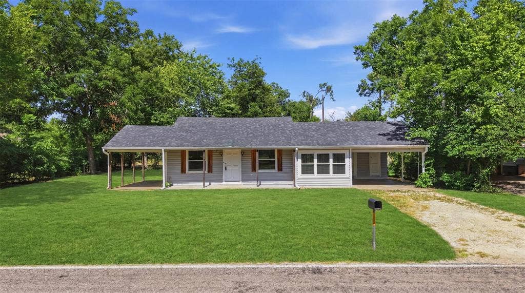 337 N 1st Street, Point, TX 75472 Ranch-style exterior with gray siding, a dark gray shingle roof, and a covered front porch featuring white support columns