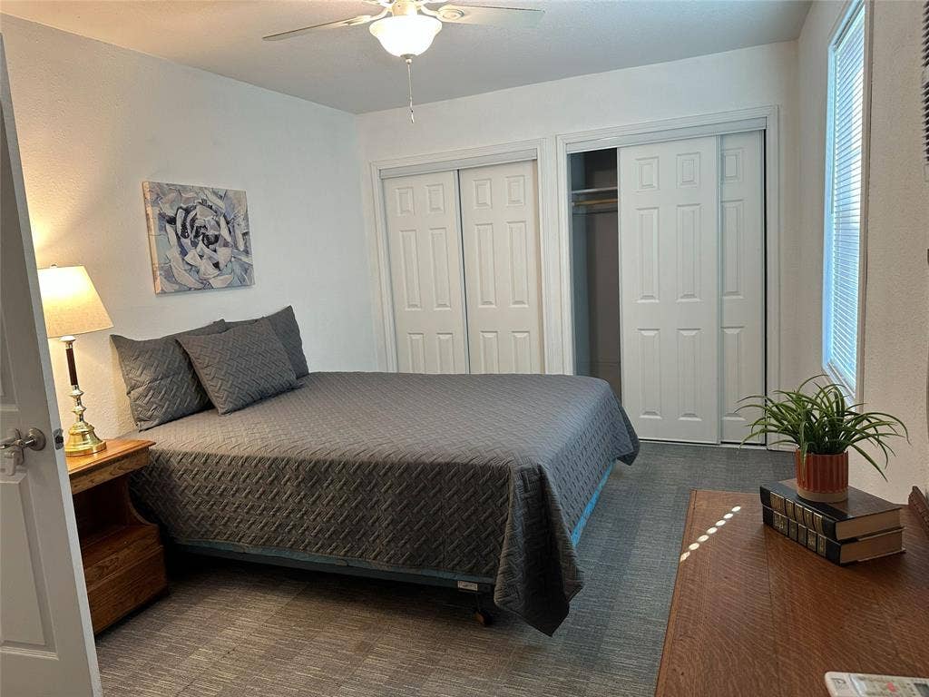 144 Huntoon Trail, Mabank, TX 75156 Main bedroom with closets and ceiling fan and access to backyard