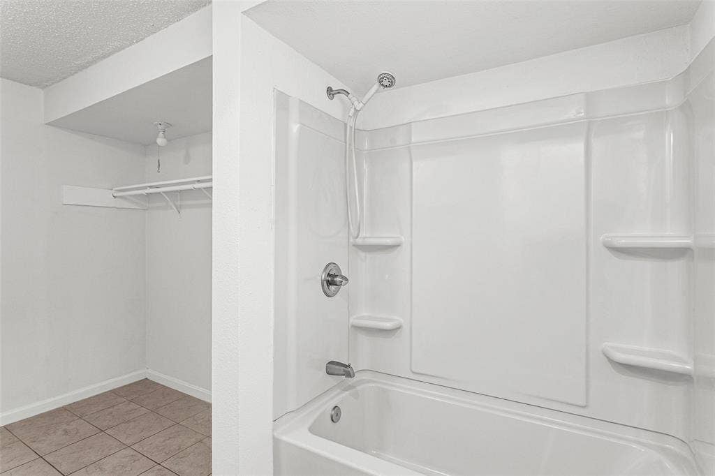 529 Georgetown Drive, Everman, TX 76140 Tub and shower combination with a single-handle fixture and integrated shelving