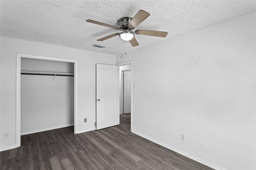 529 Georgetown Drive, Everman, TX 76140 Spacious room featuring wood-finish flooring, white walls, and a ceiling fan with integrated lighting