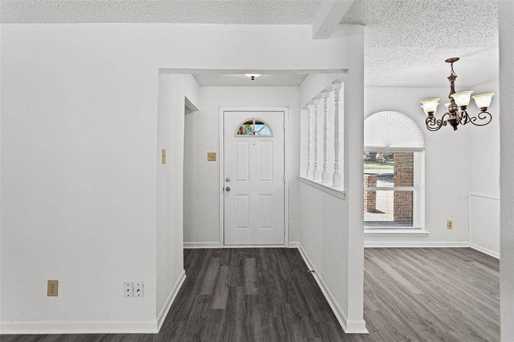 529 Georgetown Drive, Everman, TX 76140 Entryway featuring wood-finish flooring and a decorative half-wall with spindles