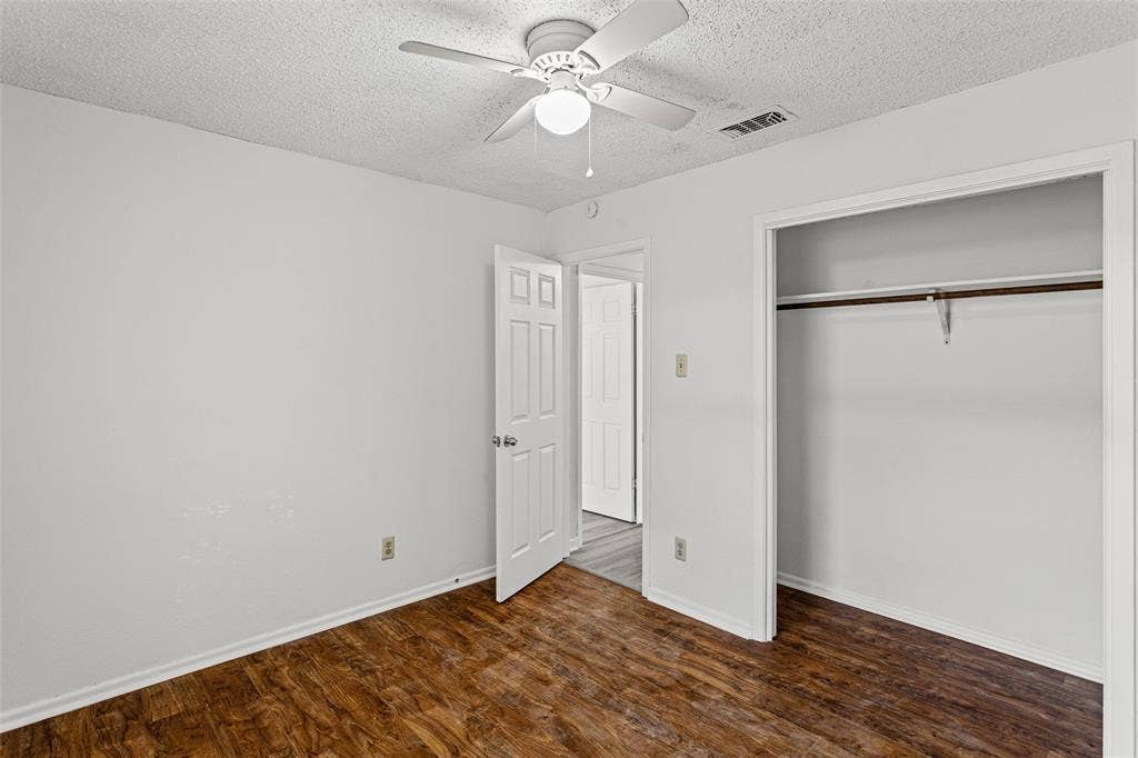 529 Georgetown Drive, Everman, TX 76140 Interior room featuring wood-finish flooring, white walls, and a ceiling fan