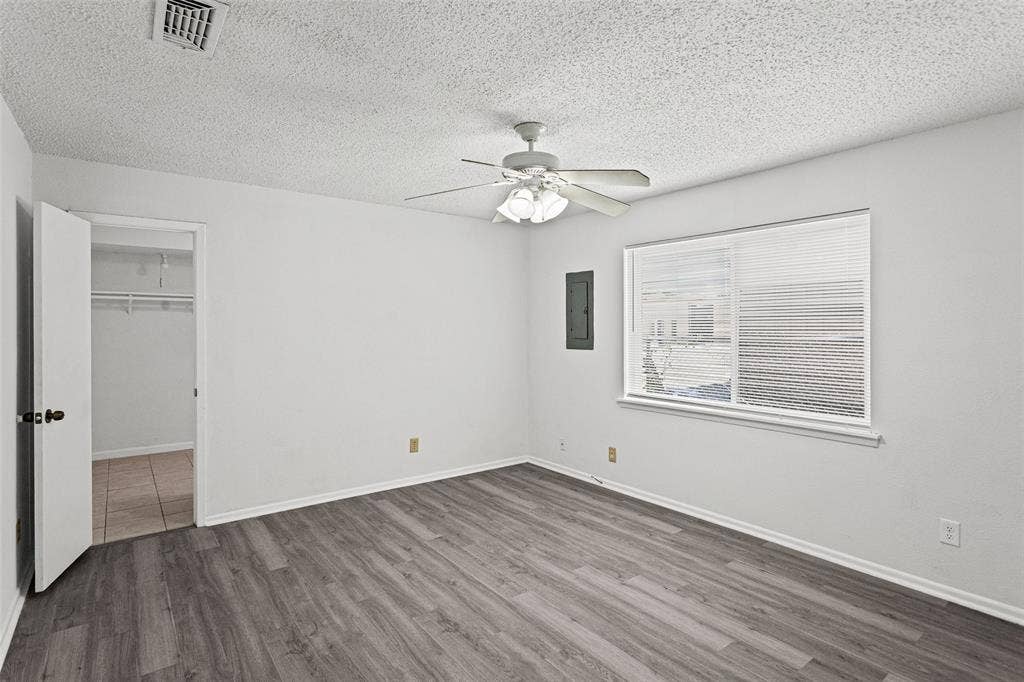 529 Georgetown Drive, Everman, TX 76140 Spacious room featuring wood-finish flooring and a ceiling fan