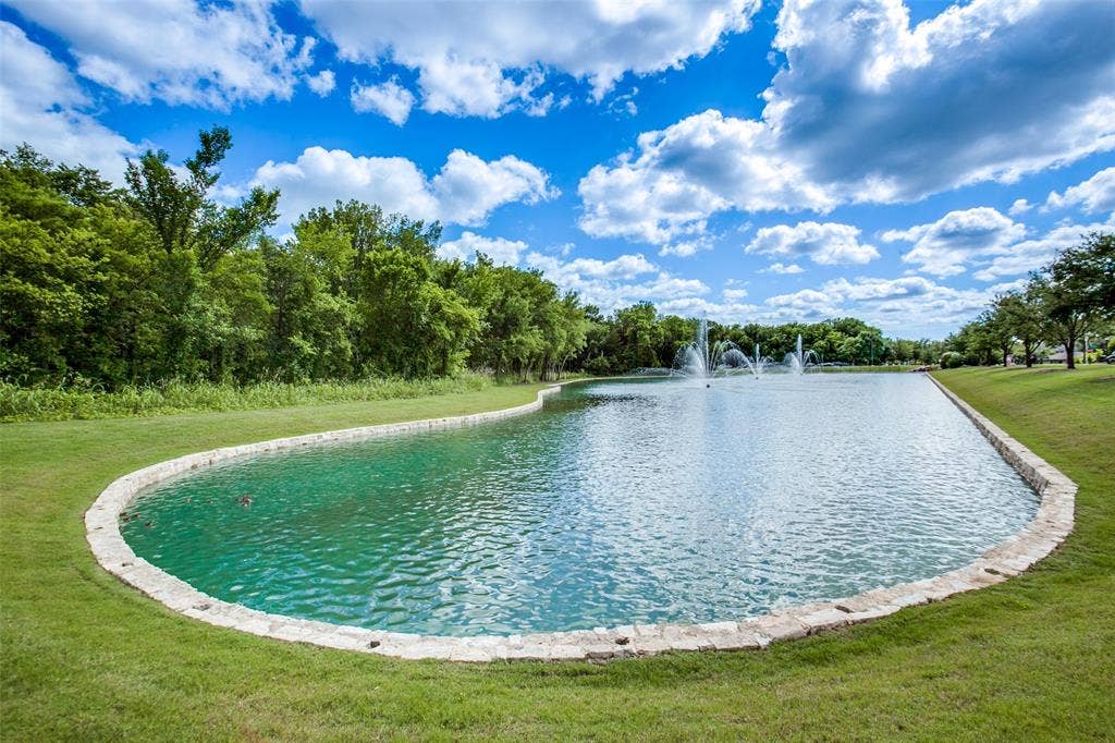 1006 Emil Place, Allen, TX 75013 Expansive water feature with multiple fountains and a stone-lined border