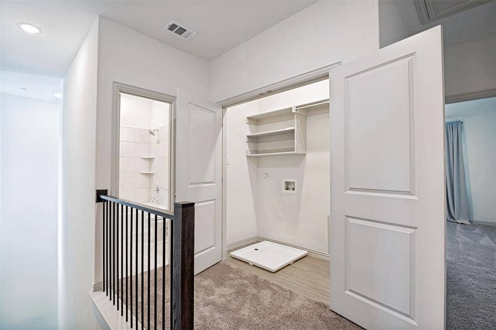 1006 Emil Place, Allen, TX 75013 Upper-level hallway featuring a built-in laundry closet with shelving and utility hookups