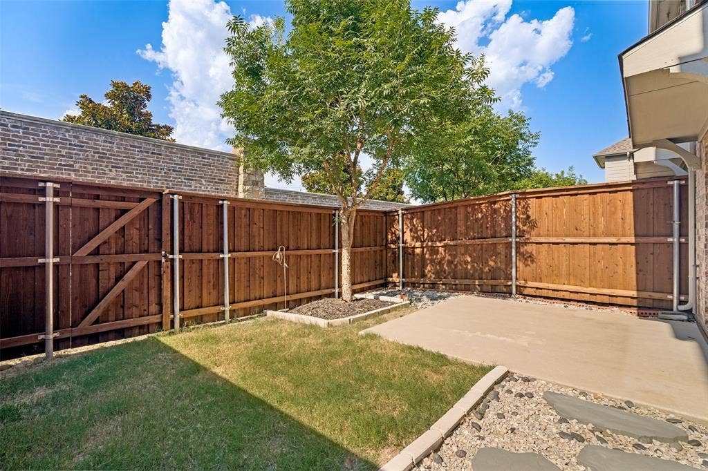 1006 Emil Place, Allen, TX 75013 Private backyard featuring a concrete patio, a grass lawn, and a mature tree