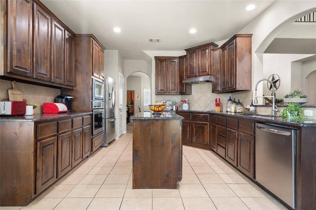 2101 Trinity Lane, Wylie, TX 75098 Kitchen anchors the heart of the kitchen.
