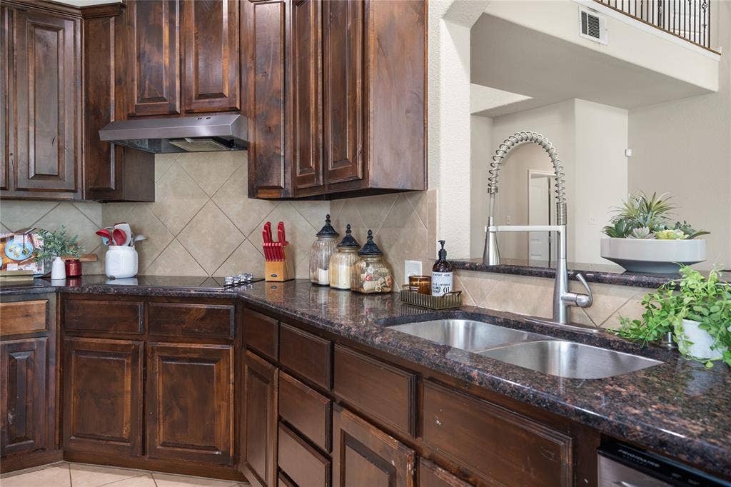 2101 Trinity Lane, Wylie, TX 75098 Dark cabinetry and granite throughout.