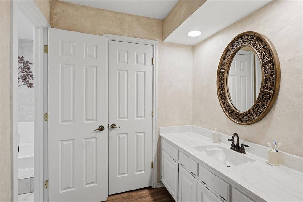 5711 Cortez Drive, Granbury, TX 76049 Bathroom vanity featuring a single sink with a dark-toned faucet, white countertop, and white cabinetry
