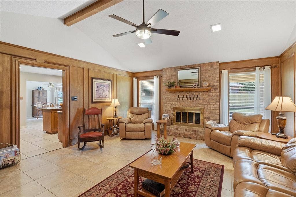 5711 Cortez Drive, Granbury, TX 76049 Living area featuring a vaulted ceiling with exposed wood beams and a ceiling fan