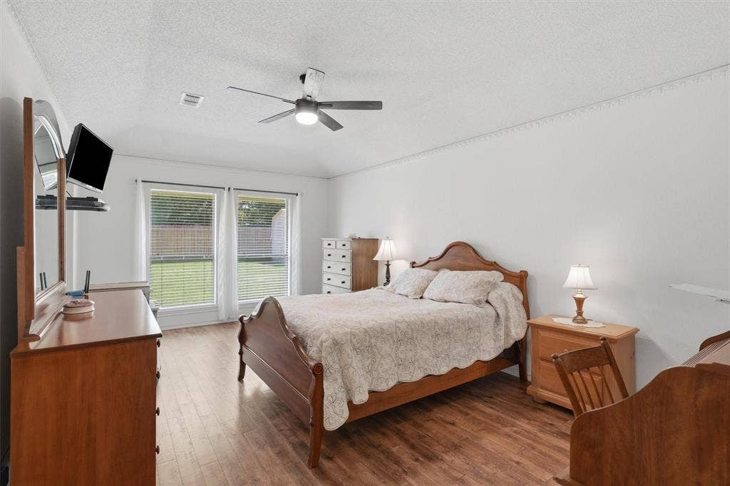 5711 Cortez Drive, Granbury, TX 76049 Bright room featuring wood-finish flooring and white walls
