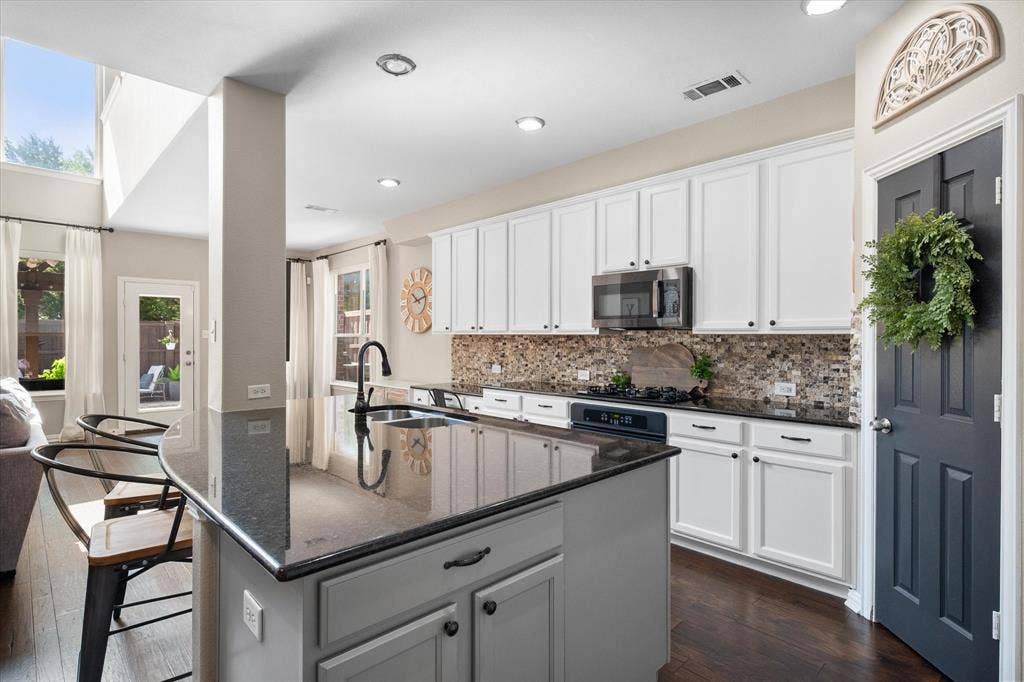 12032 Terrazzo Lane, Frisco, TX 75035 Spacious breakfast nook, glass-paneled exterior door, and a geometric pendant light fixture overlooking the backyard!