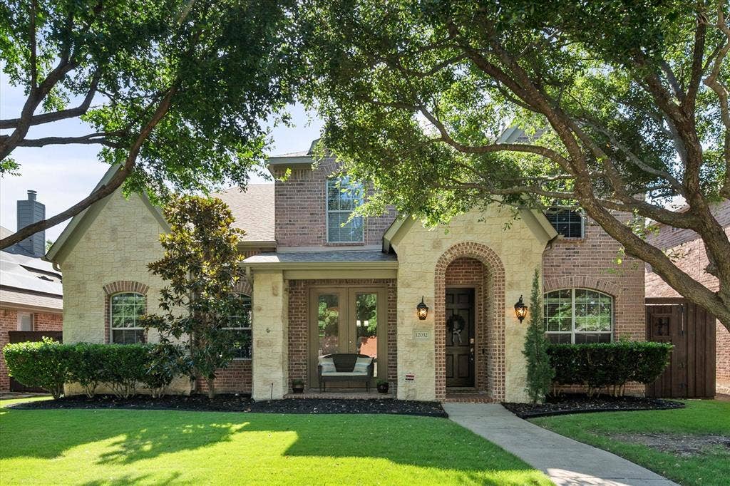 12032 Terrazzo Lane, Frisco, TX 75035 Beautiful Stone facade with arched entryway along with French doors and a covered porch!