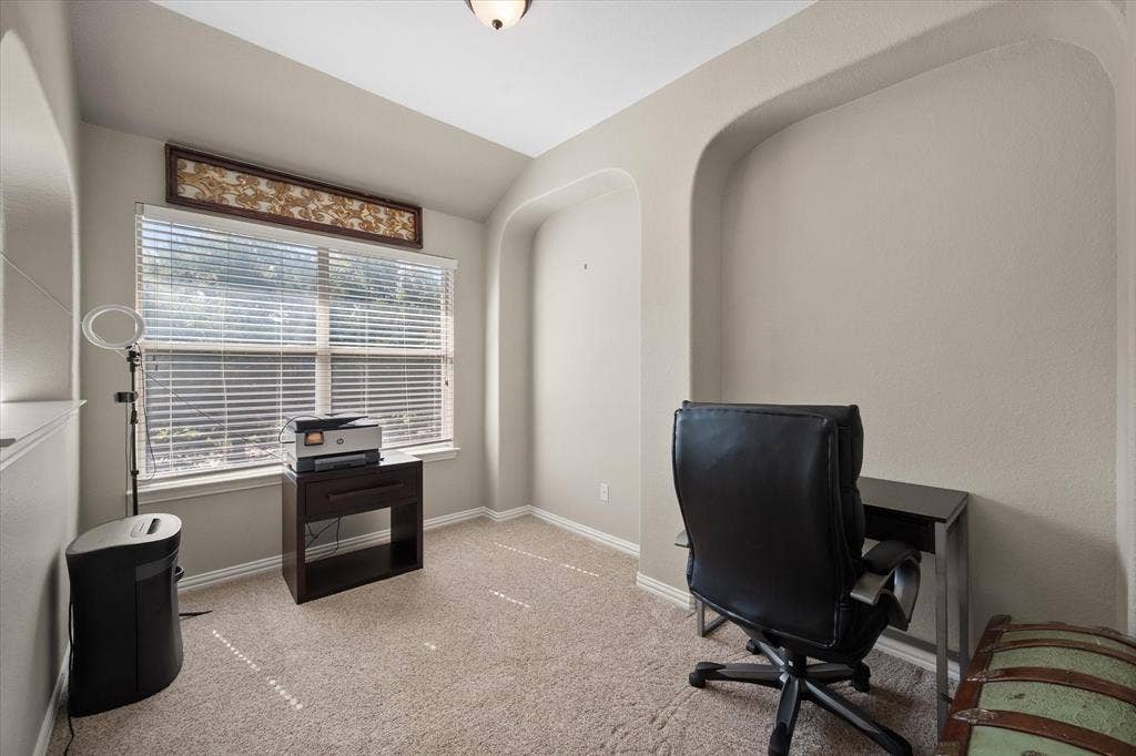 12032 Terrazzo Lane, Frisco, TX 75035 Carpeted room featuring a large window with blinds, recessed wall alcoves, and a ceiling light fixture