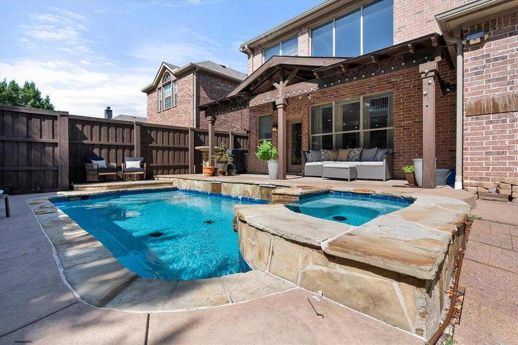 12032 Terrazzo Lane, Frisco, TX 75035 Outdoor entertaining area featuring a rectangular pool with integrated spa and stone coping!