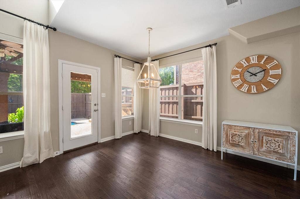 12032 Terrazzo Lane, Frisco, TX 75035 Spacious breakfast nook, glass-paneled exterior door, and a geometric pendant light fixture overlooking the backyard!