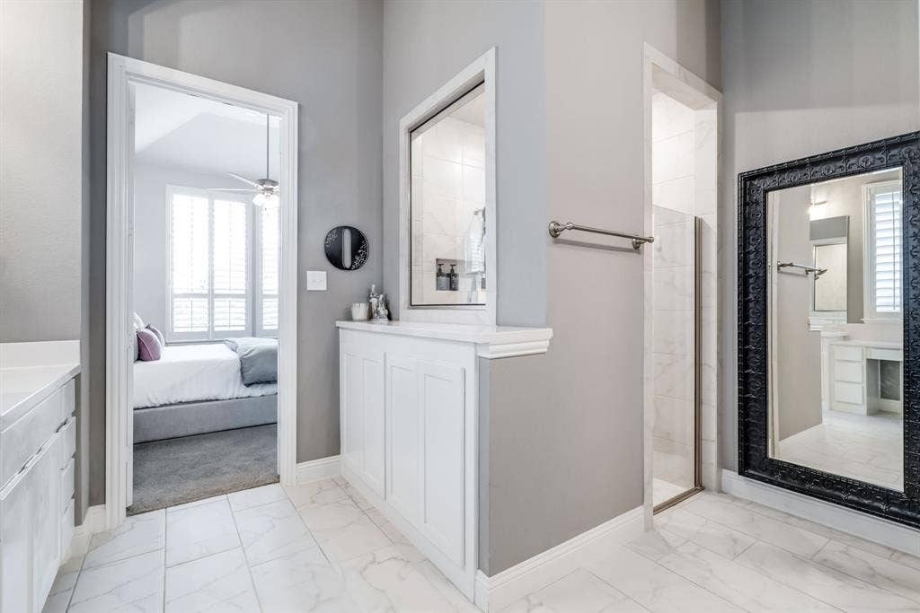 Tile flooring with a subtle pattern throughout, featuring a built-in white cabinetry unit with a countertop