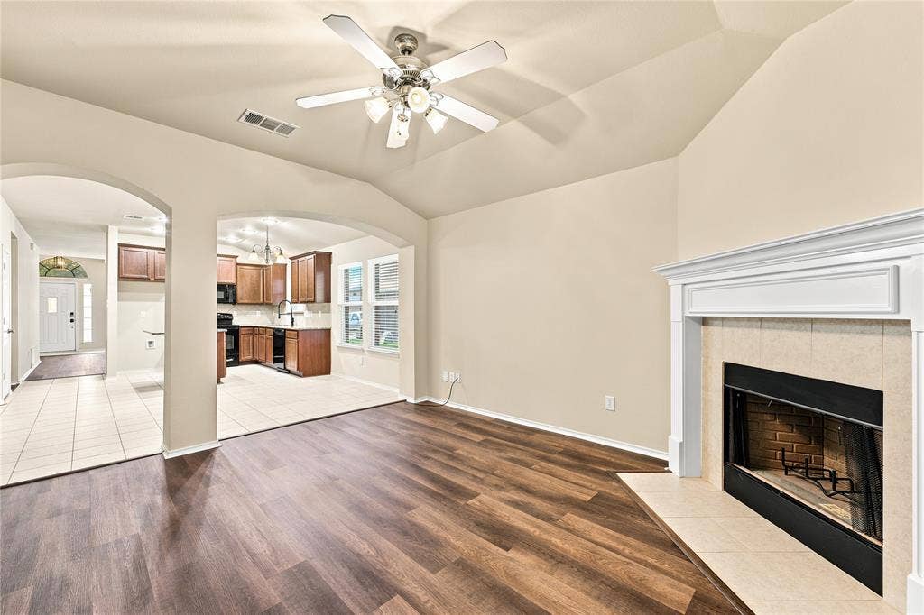 Living area with vaulted ceilings and wood-finish flooring
