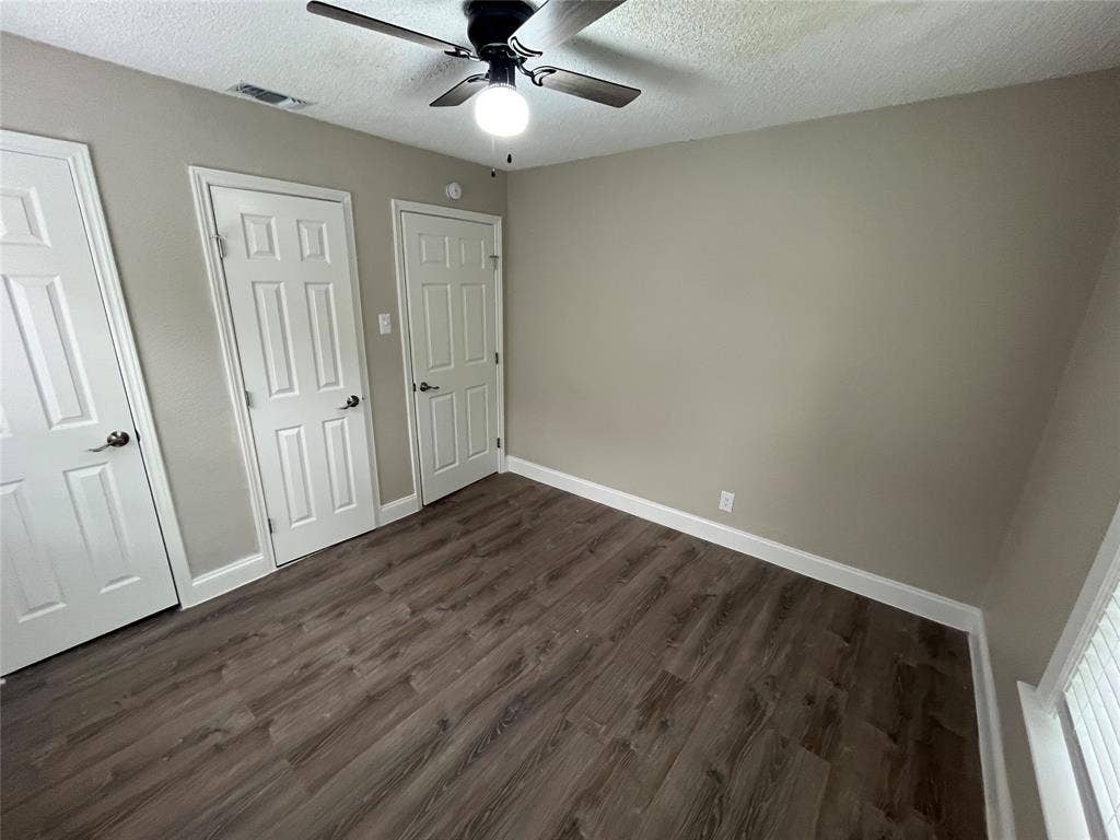 719 Fairwood Drive, Dallas, TX 75232 Interior room featuring wood-finish flooring, light neutral wall paint, and white trim